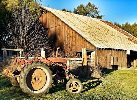 Tractor in front of the old barn across from the Park office.